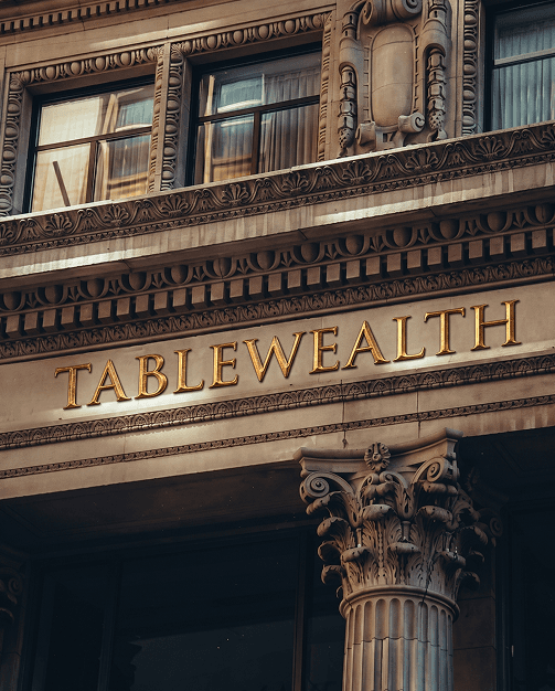 Tablewealth engraved on a building facade
